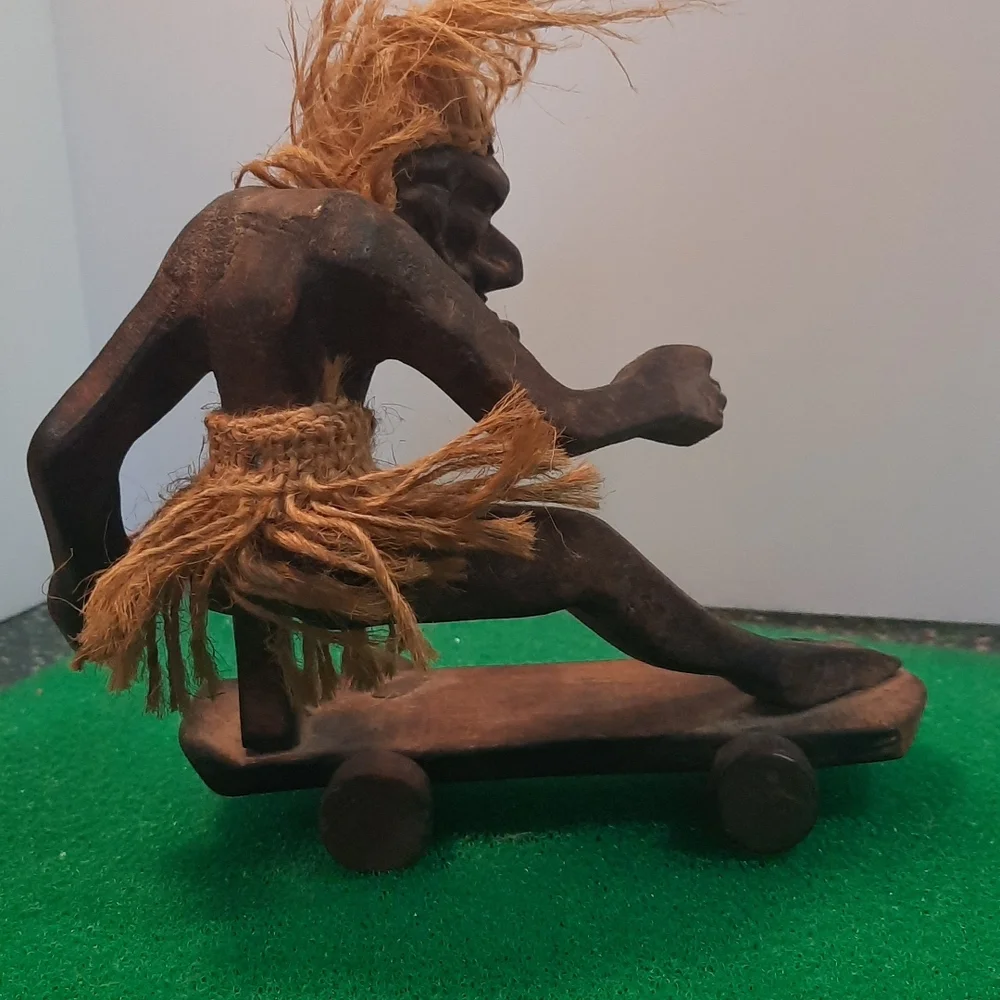 Hand carved wooden Hawaiian Tiki skateboard dude
